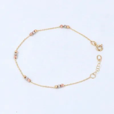 Bracelet in yellow, white, yellow and rose gold with diamond-cut balls