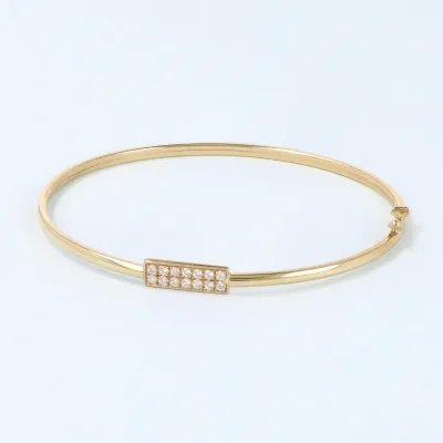 Yellow gold bangle with polish finish and row of zirconia