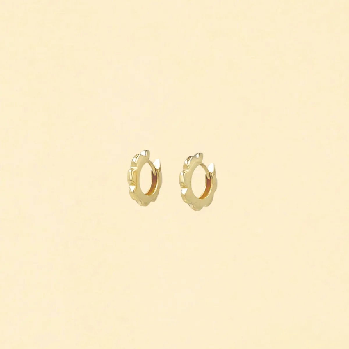 Yellow gold hoop earrings in the shape of a stylized flower