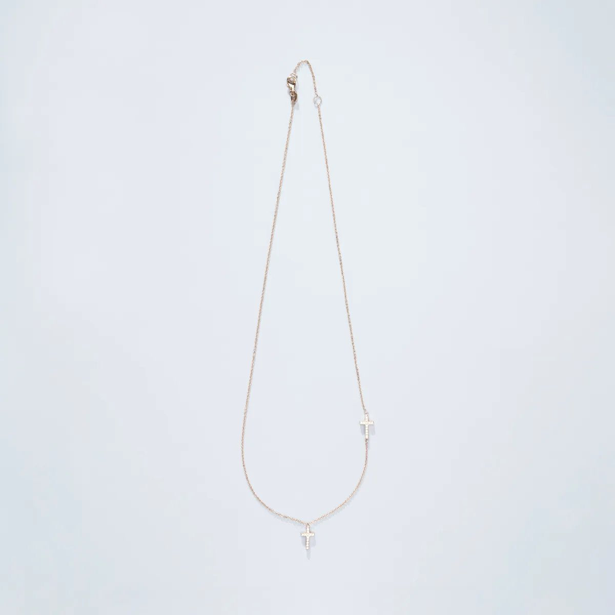 Yellow gold necklace with two crosses and zircons