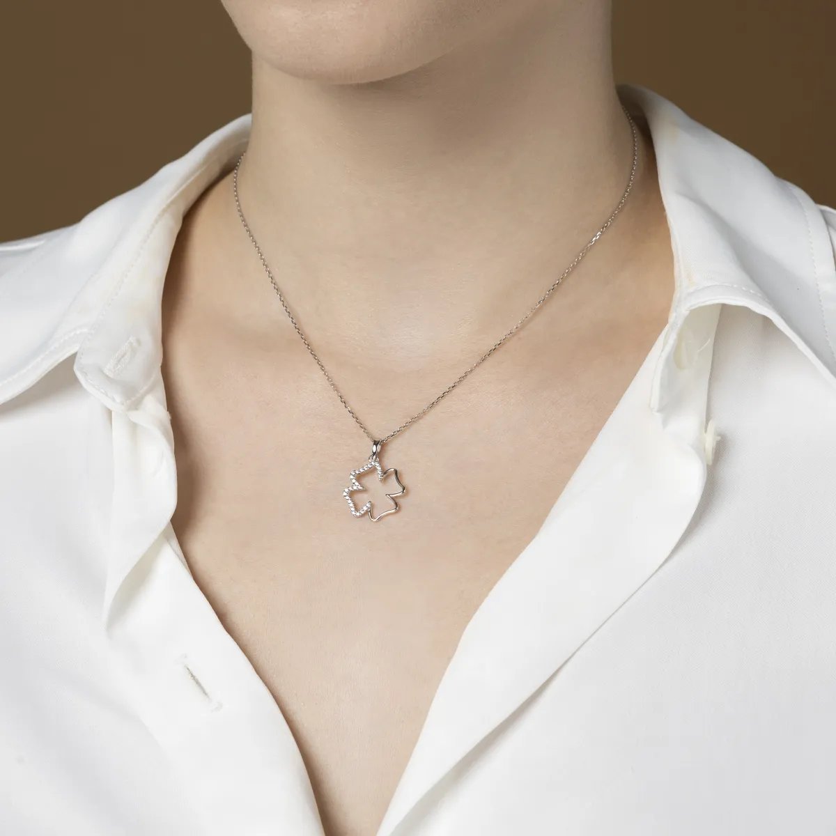 White gold pendant in the shape of a larch with cubic zirconia line