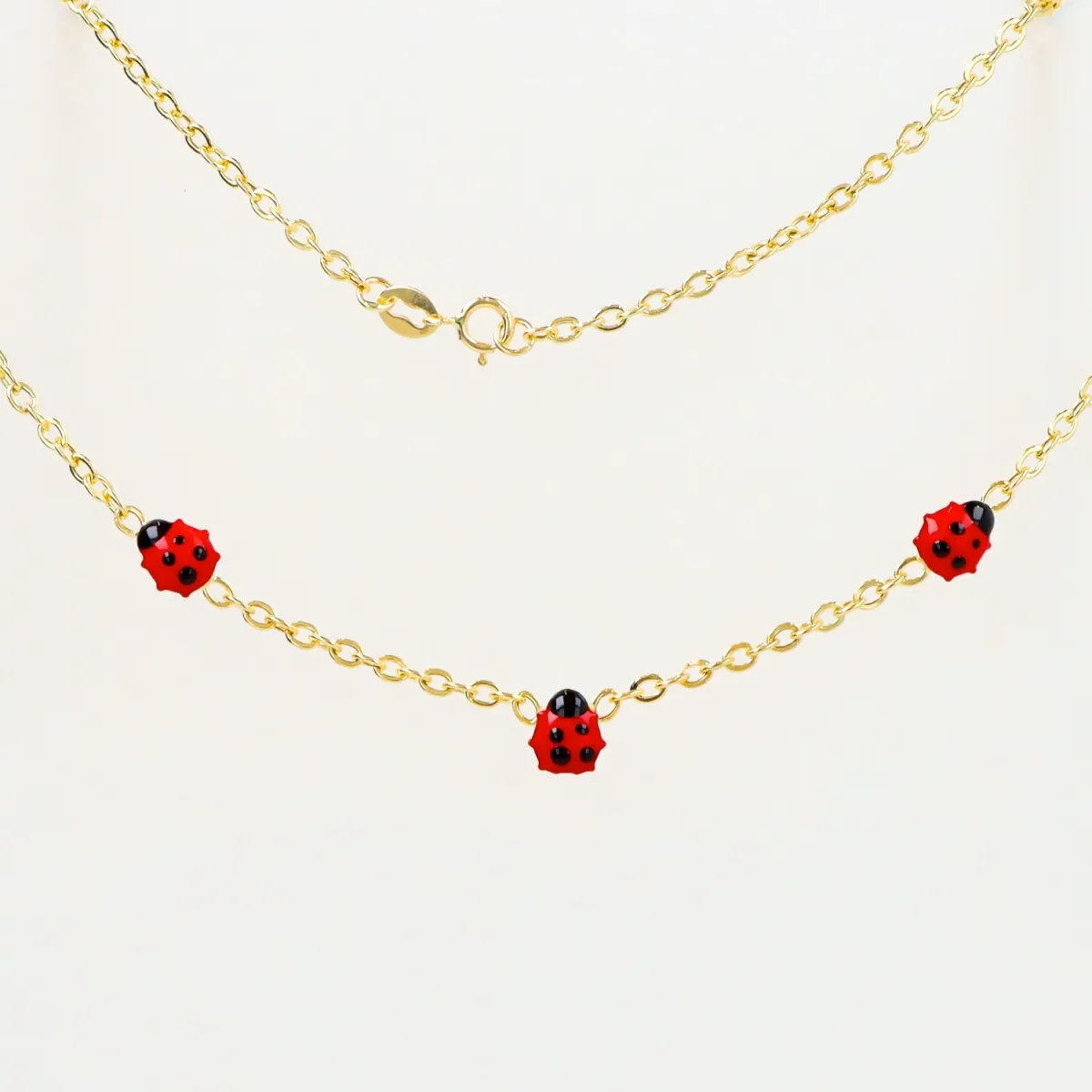 Yellow gold children's necklace with enameled ladybugs
