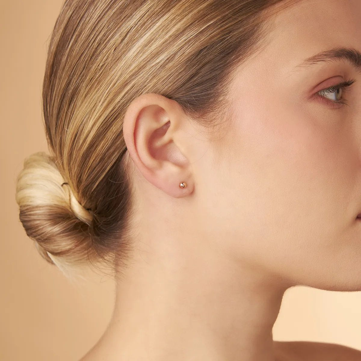 Rose gold stud earrings in the shape of a sphere