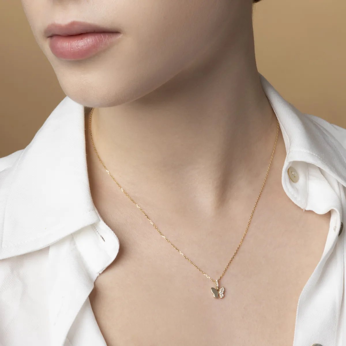 Yellow gold butterfly-shaped pendant with cubic zirconia