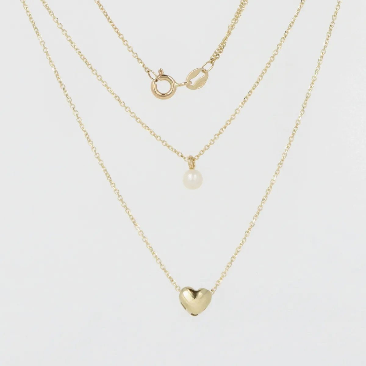 Multi-strand yellow gold necklace with heart pendant and pearl