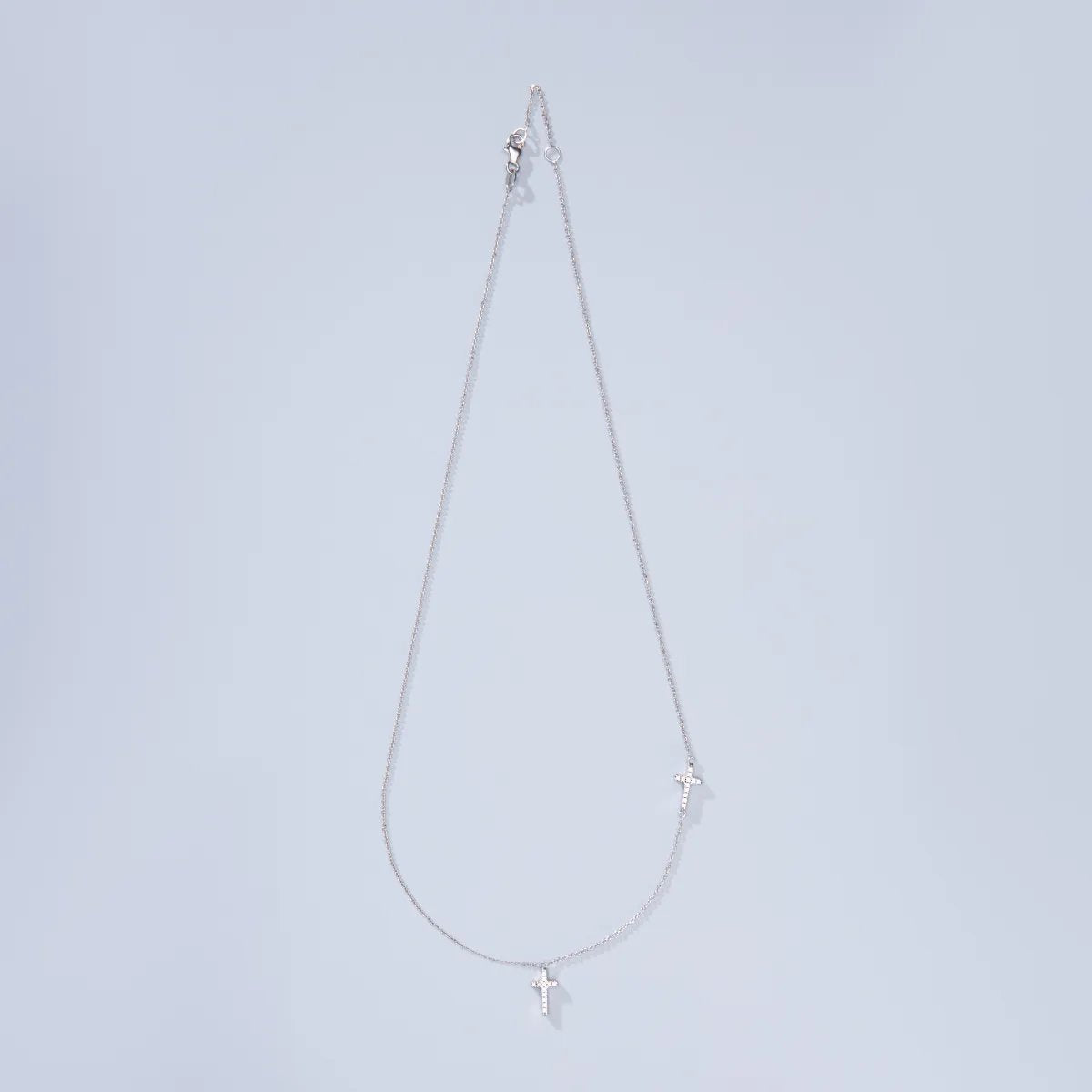 White gold necklace with two crosses and zircons