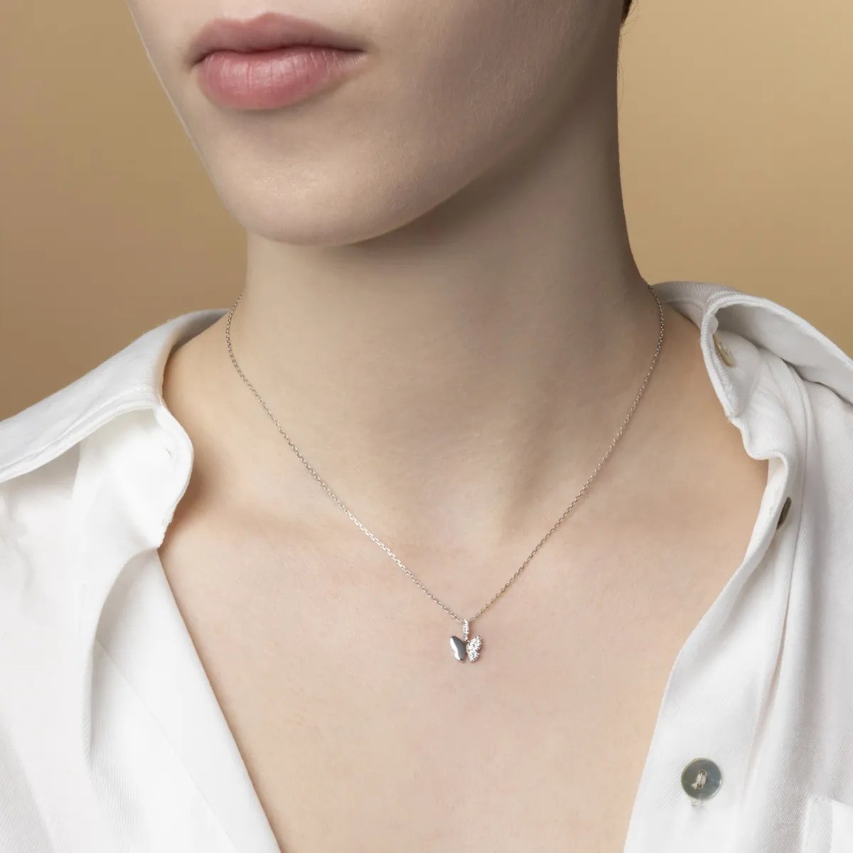 White gold butterfly-shaped pendant with cubic zirconia