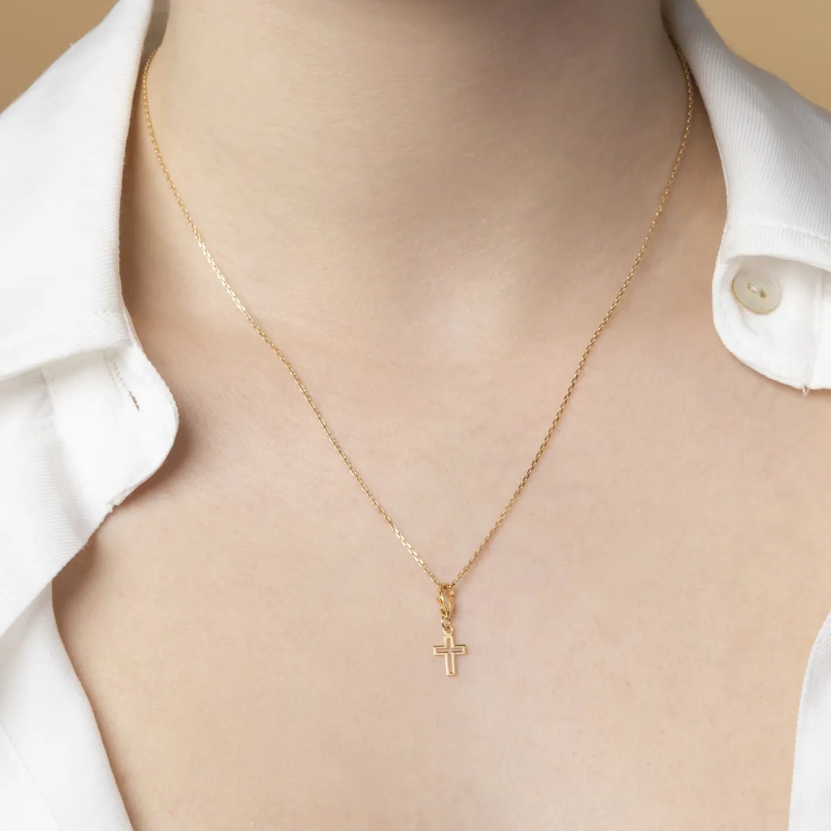 Yellow gold cross-shaped charm pendant