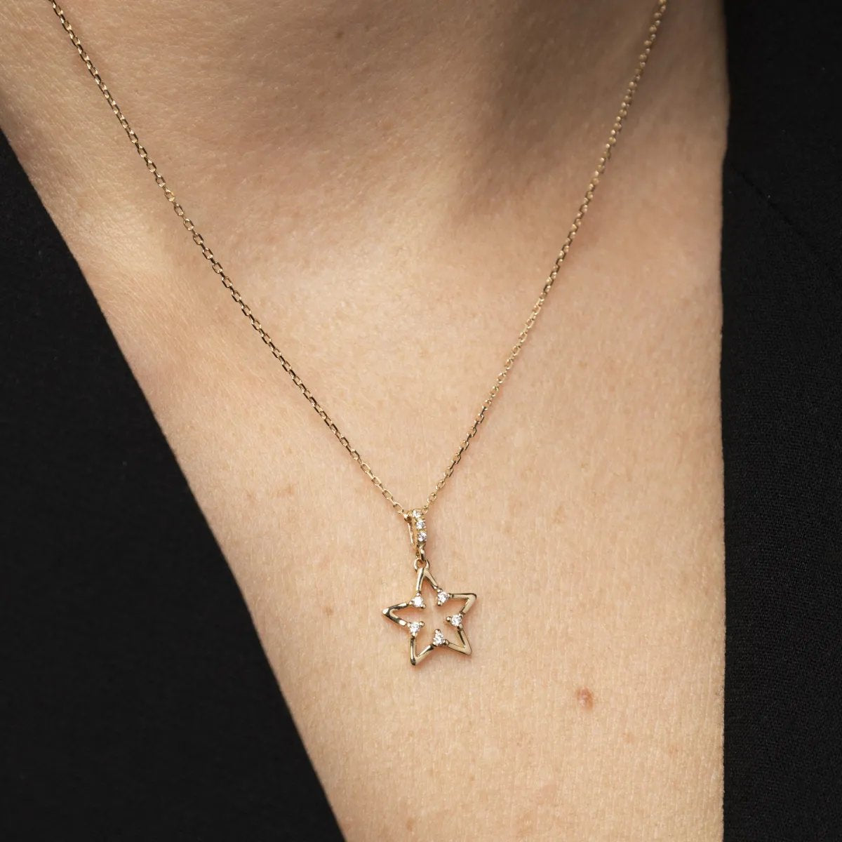 White and yellow gold moon-shaped pendant with cubic zirconia