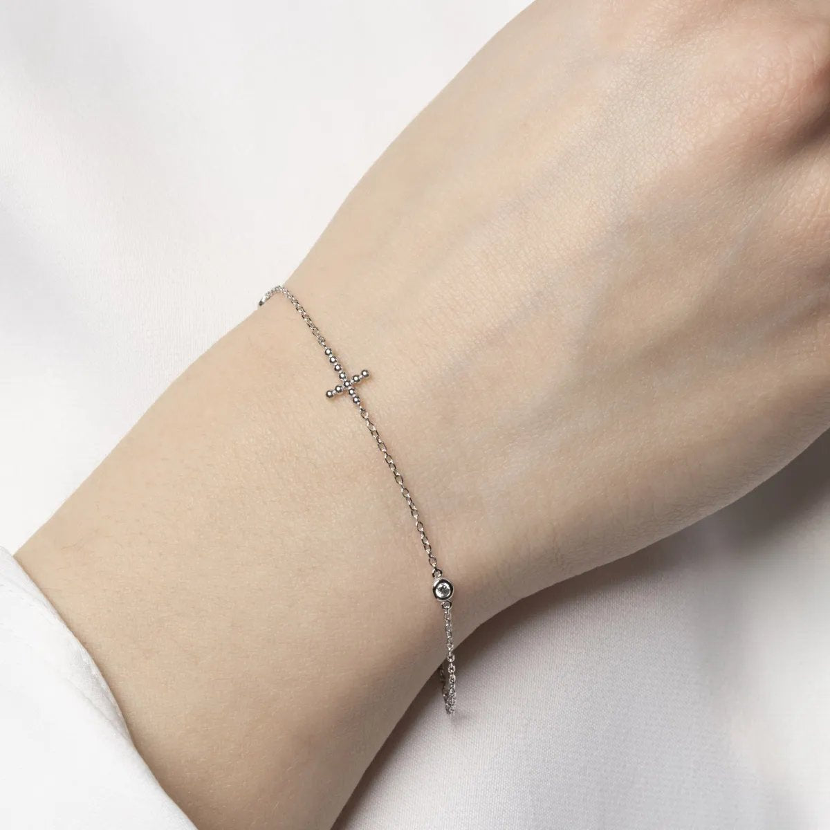 White gold bracelet with cross and cubic zirconia