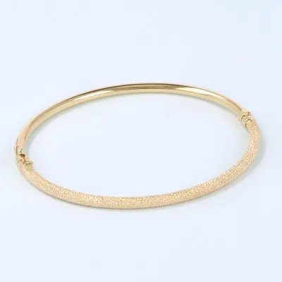 Yellow gold bangle with diamond-cut finish