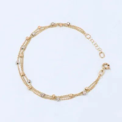 Lightweight three-row bracelet in white and yellow gold with diamond-cut beads