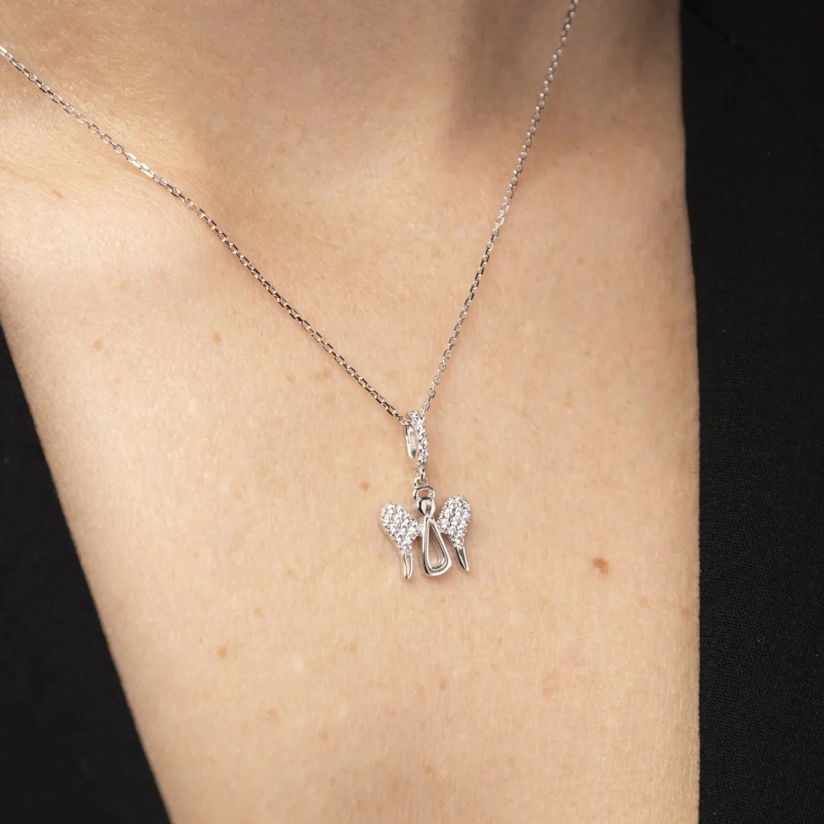 White gold angel-shaped pendant with cubic zirconia