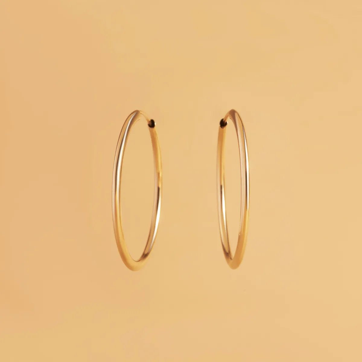 Yellow gold flex tube earrings 25 mm