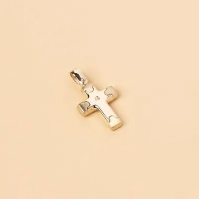 Yellow gold cross pendant with one small cz