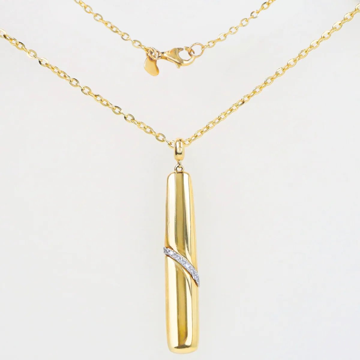 Yellow gold necklace with rectangular pendant with diagonal zirconia band
