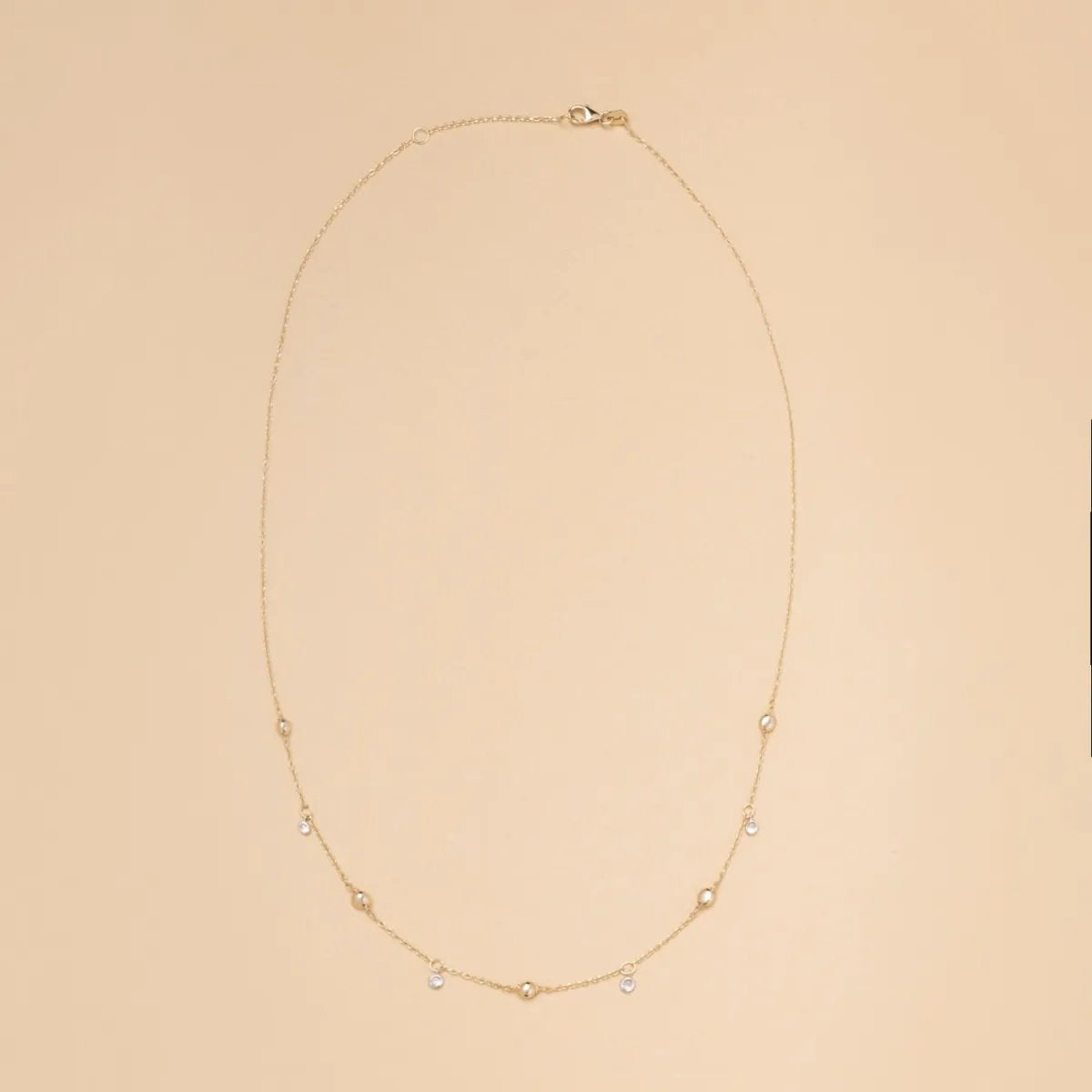 Yellow gold necklace with spheres and cubic zirconia
