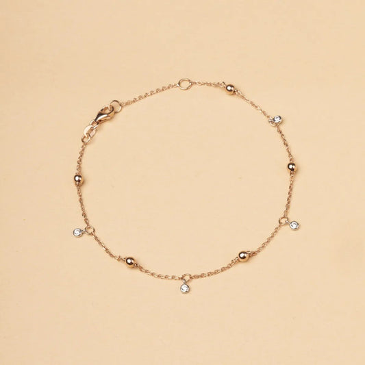 Rose gold bracelet with spheres and cubic zirconia