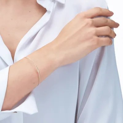 Semi-rigid light bracelet in yellow gold with diamond-cut balls