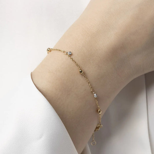 Yellow gold bracelet with spheres and cubic zirconia