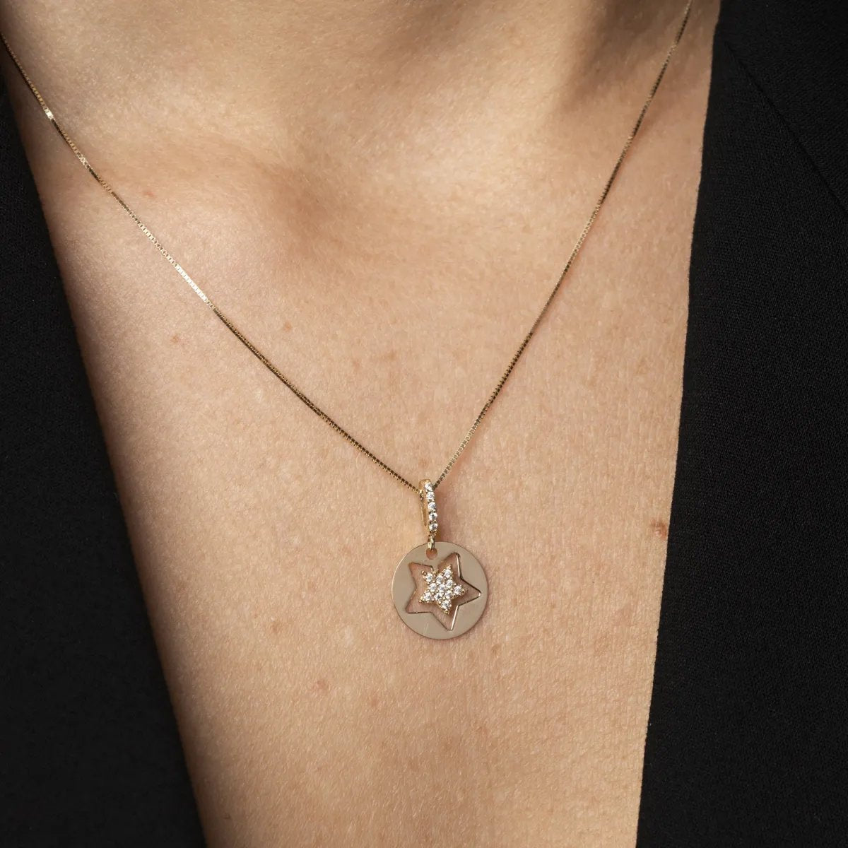 White and yellow gold star-shaped pendant with cubic zirconia