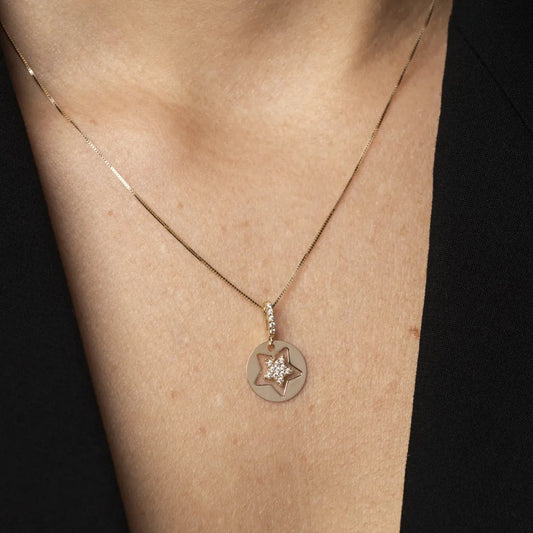 White and yellow gold star-shaped pendant with cubic zirconia