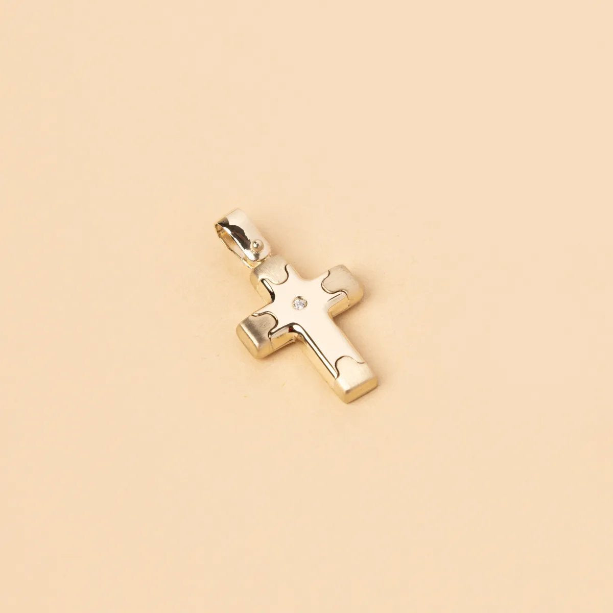 Yellow gold cross pendant with one small cz