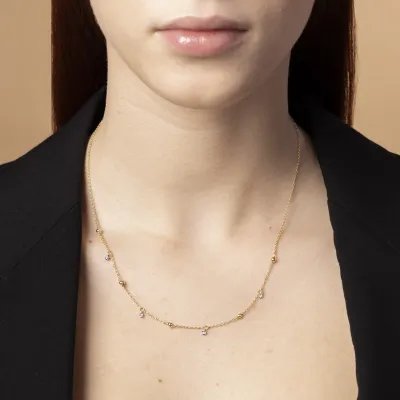 Yellow gold necklace with spheres and cubic zirconia