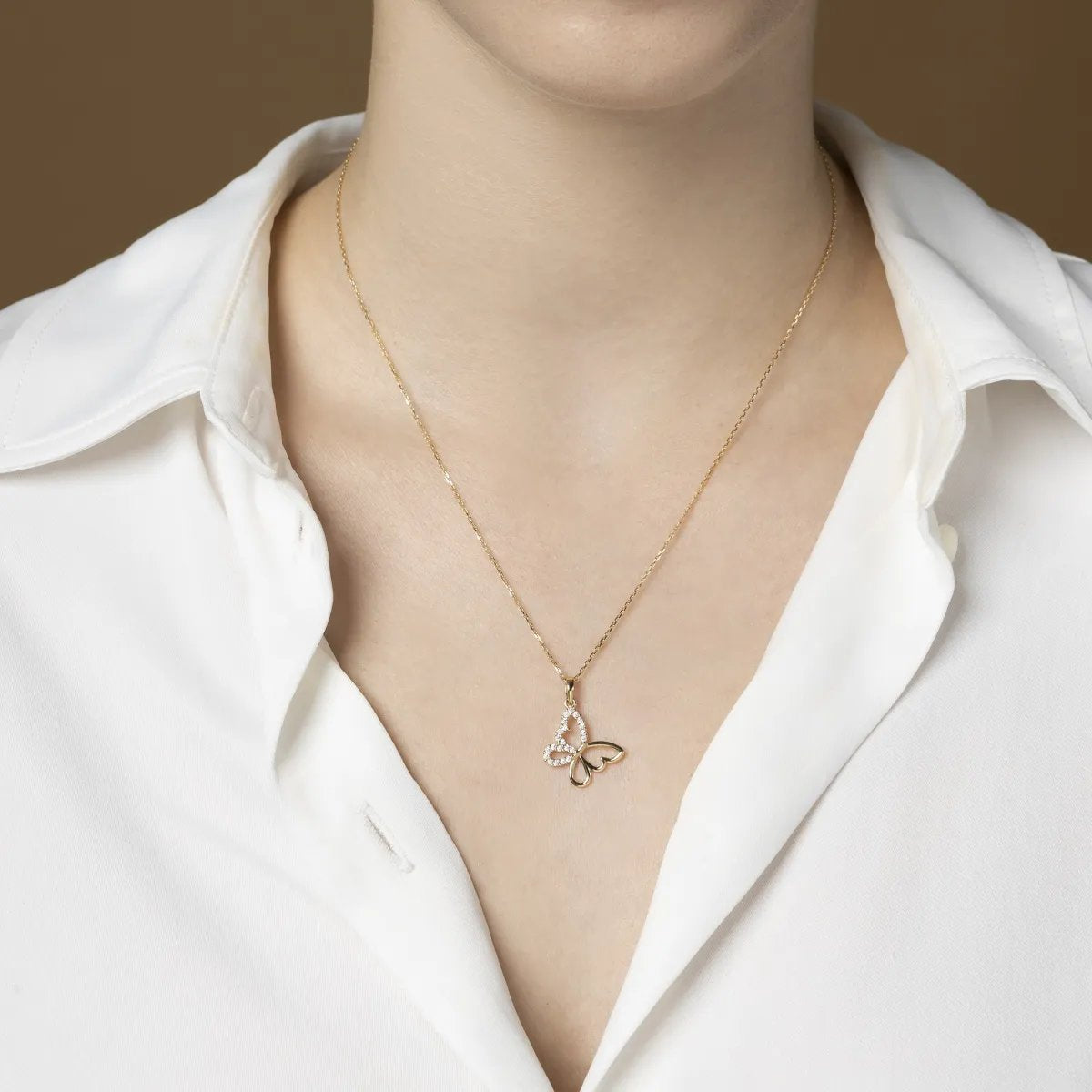 Yellow gold butterfly-shaped pendant with cubic zirconia line