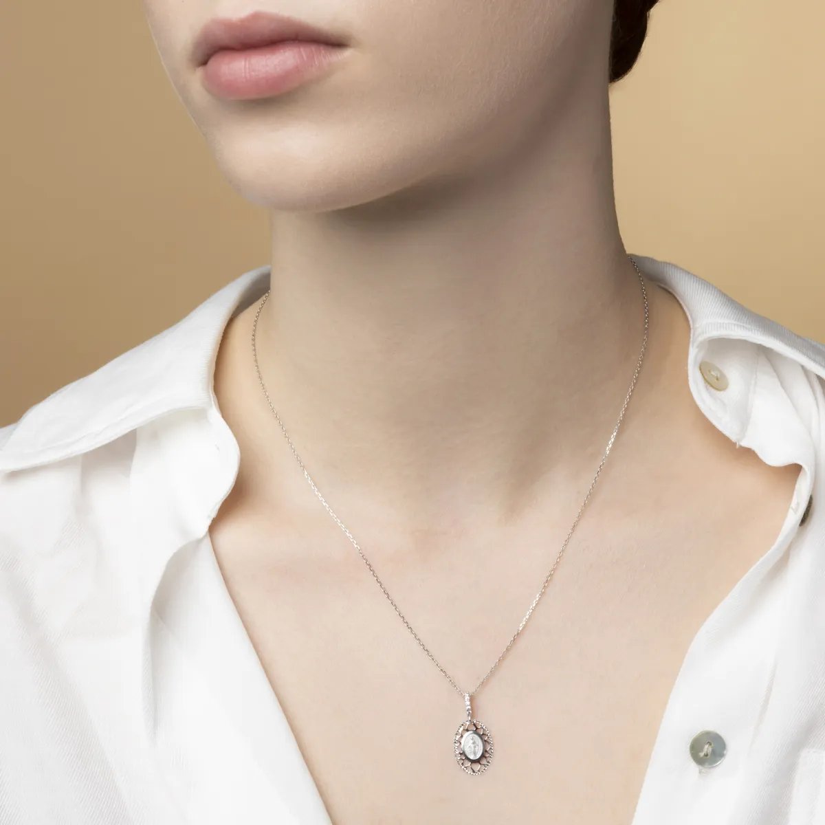 White gold medal with Miraculous Madonna with cubic zirconia